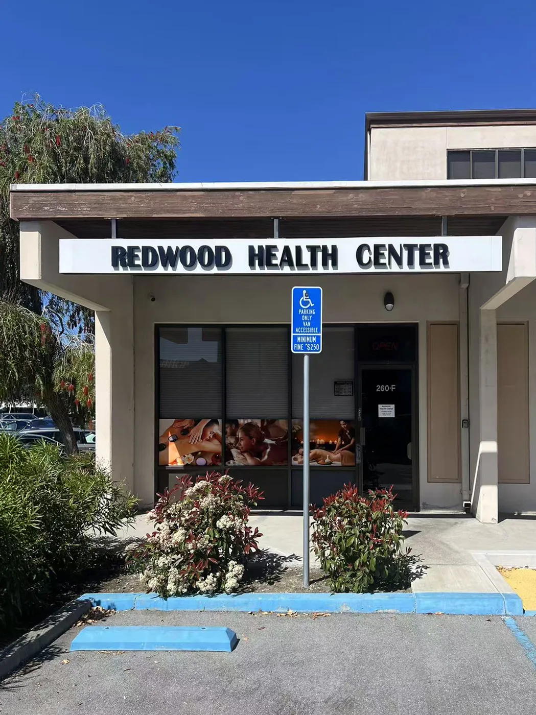 Front view of Redwood Health Center storefront with the main signage